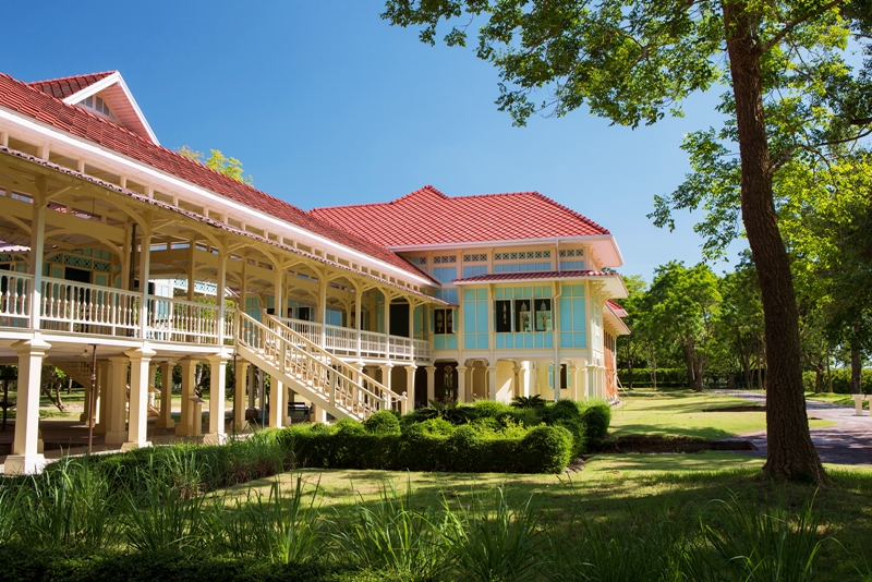 The teakwood pavilions and open corridors of Maruekhathaiyawan Palace near Cha-Am
