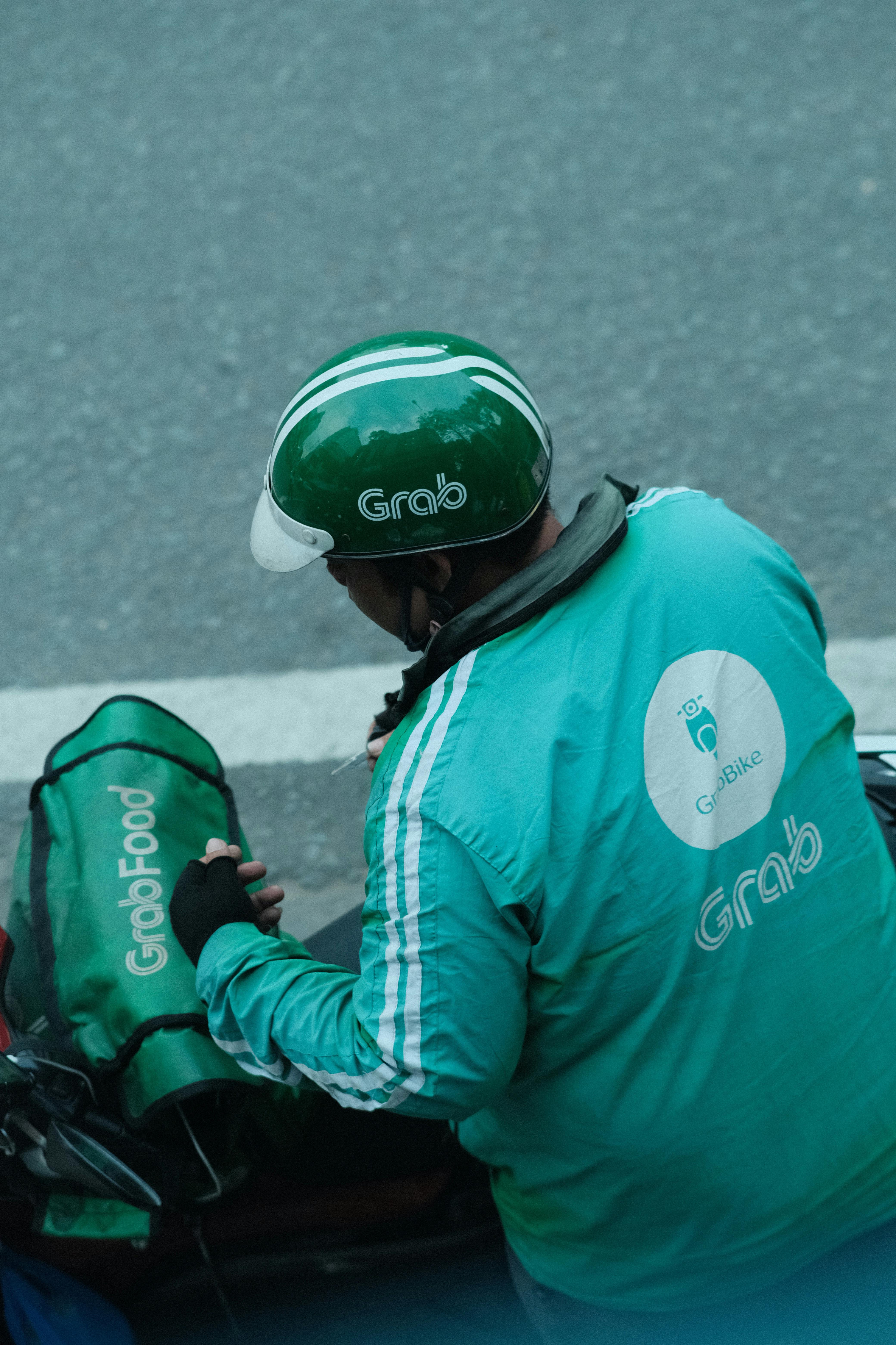 A Grab delivery driver on a motorbike in Thailand